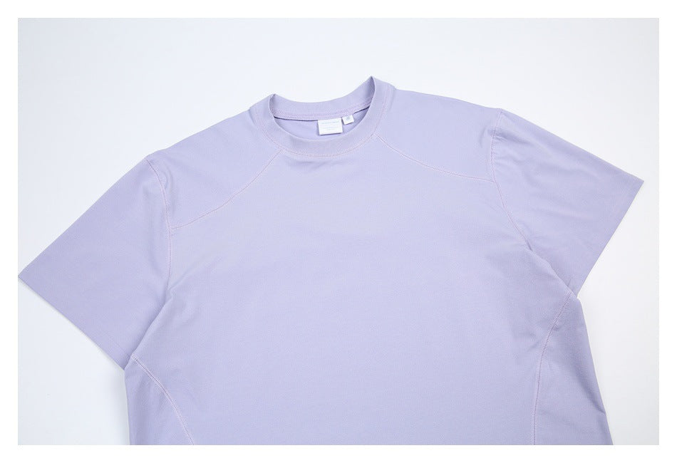 Cropped flat lay of a lavender short-sleeve crew-neck shirt with curved shoulder seams.