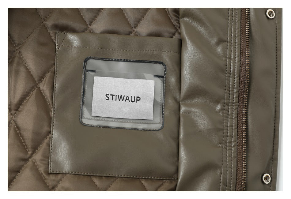 Close-up of an olive-brown jacket interior with diamond quilting, a label, zipper and snaps.