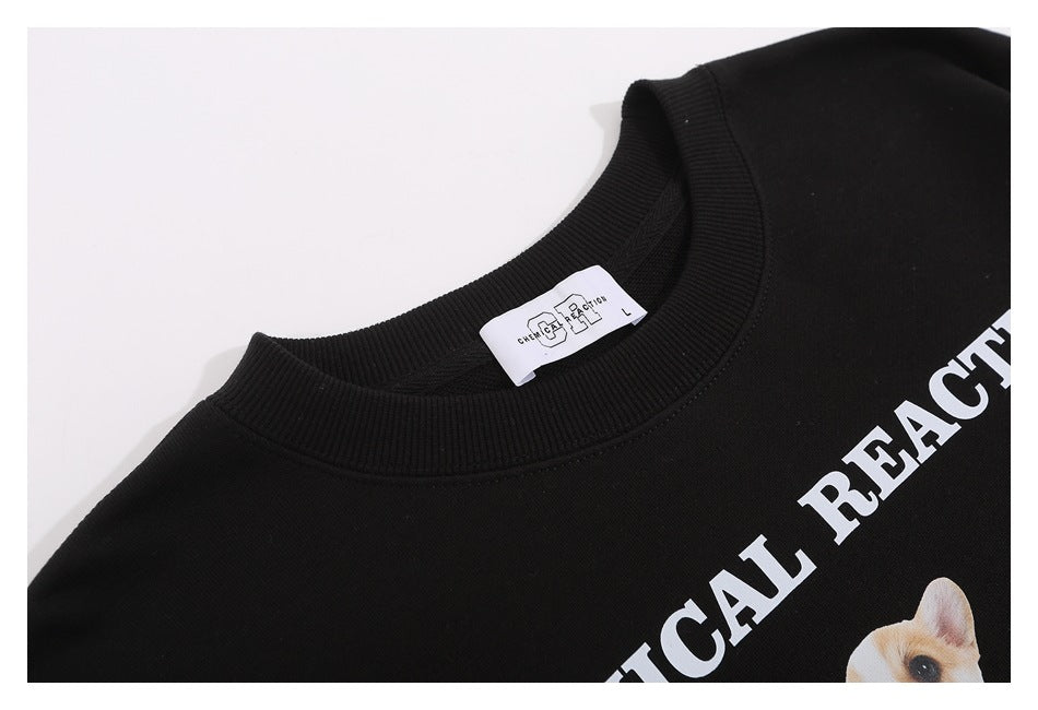Close-up of a black sweatshirt neckline and label, with part of its white dog graphic and lettering visible.