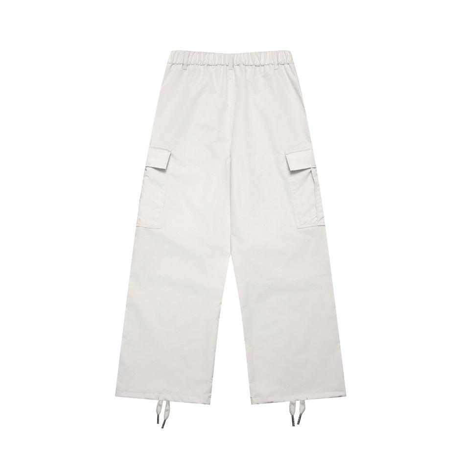 Front view of off-white wide-leg cargo pants with an elastic waistband, flap pockets and adjustable ankle cords.