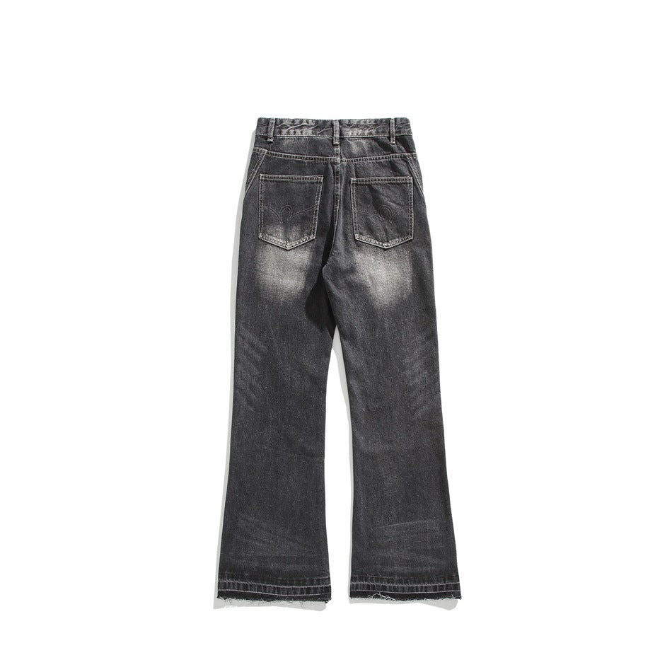Faded black flared jeans, back flat lay, with two patch pockets and frayed hem