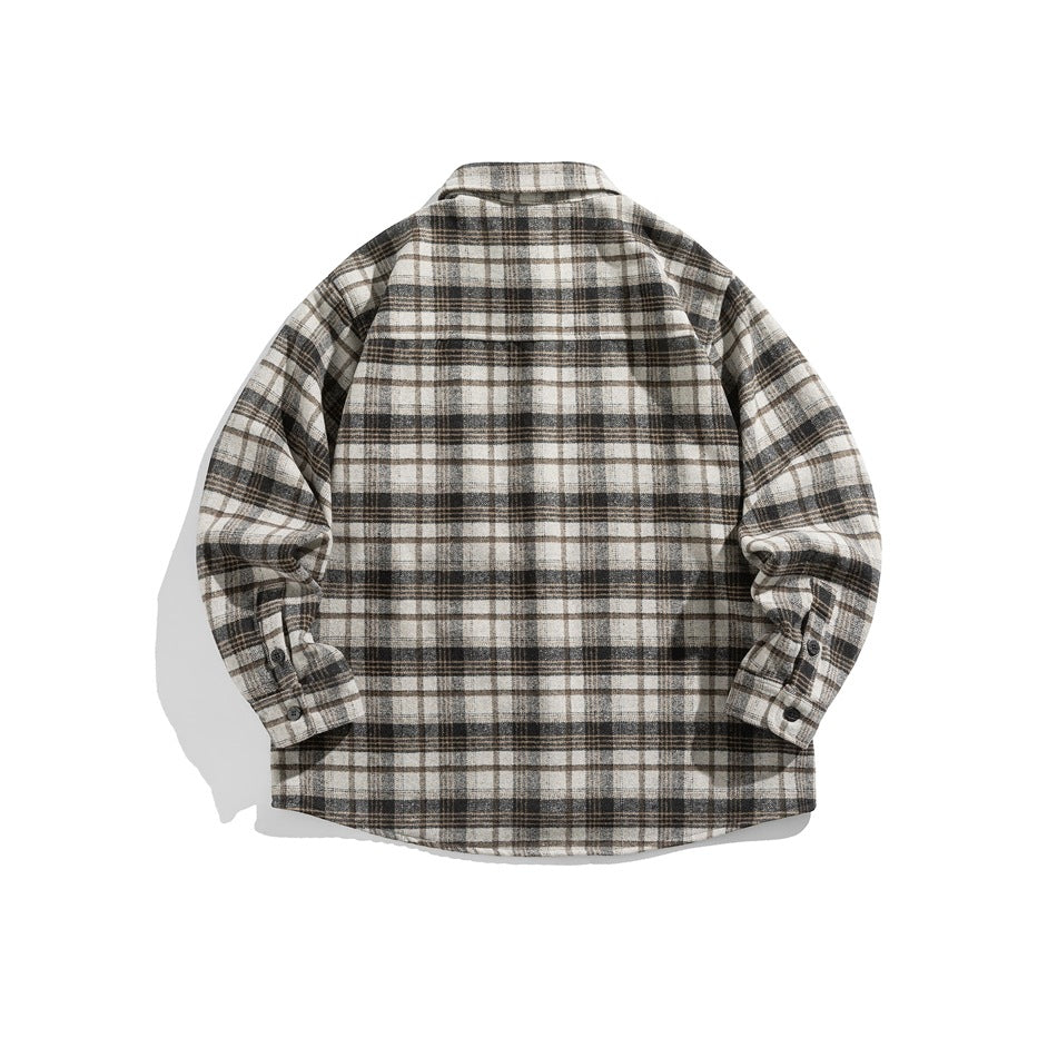 Back of a cream, black, gray and brown plaid long-sleeve shirt showing the yoke seam and button cuffs