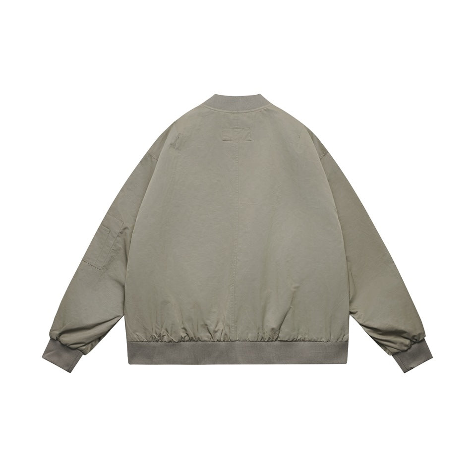Back view of a light gray-beige jacket with a small upper-back tab, gathered cuffs, and ribbed hem.