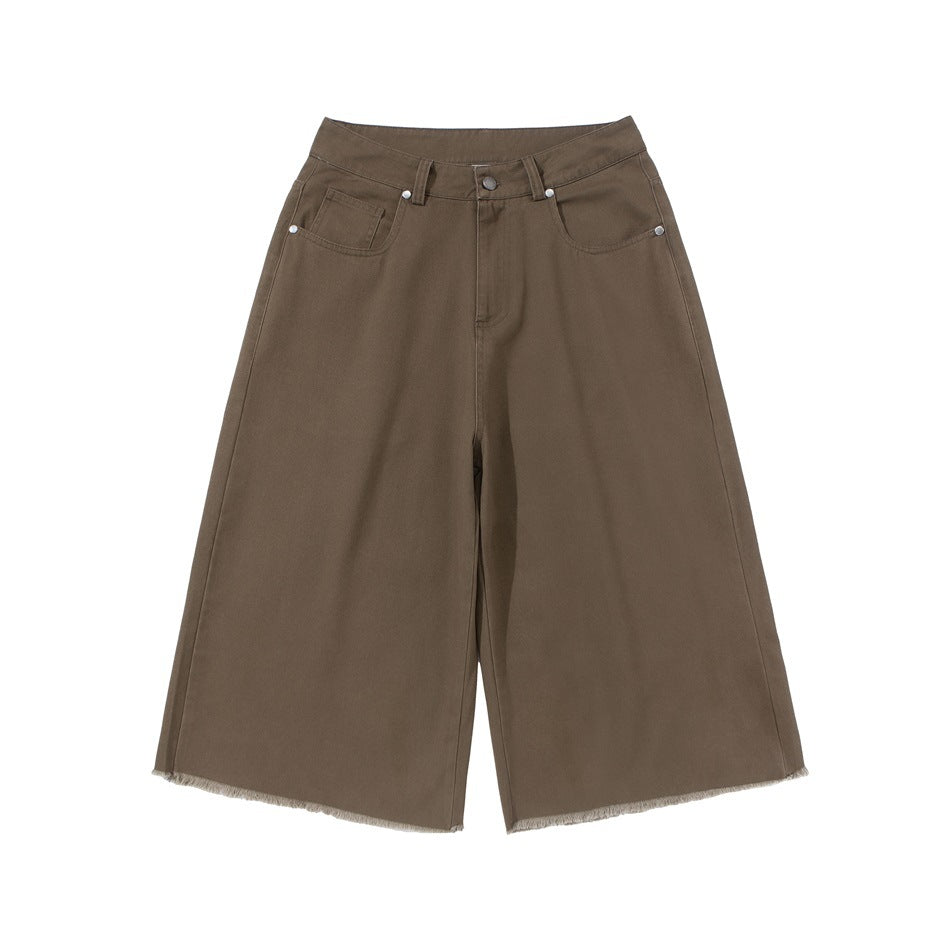 Brown wide-leg knee-length shorts, front view, with button fly, belt loops, pockets and frayed raw hem