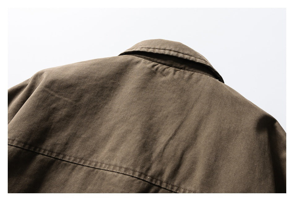 Close-up of the brown jacket's back collar and upper panel with a horizontal seam.