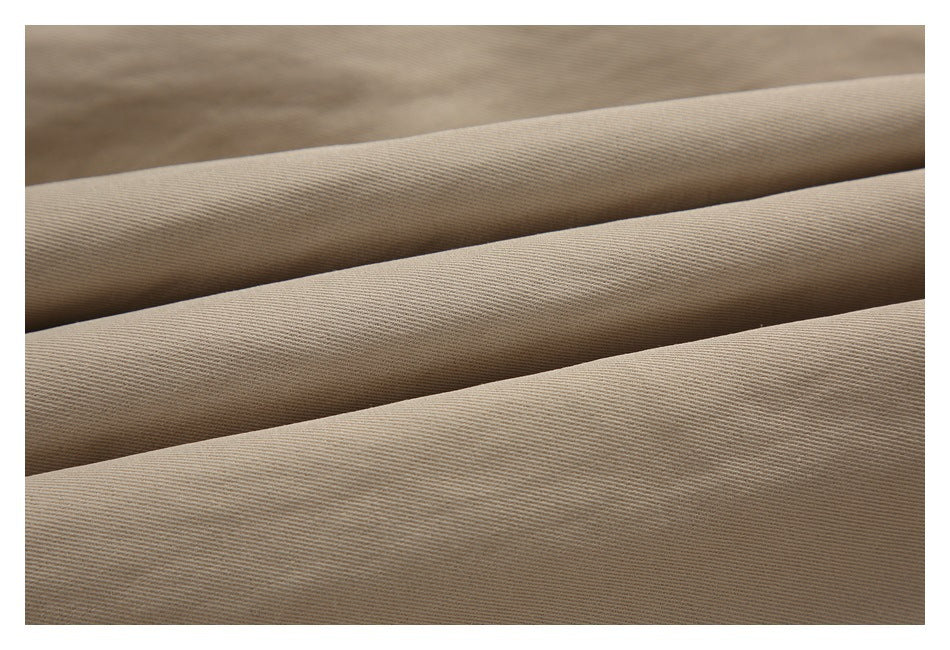 Close-up of beige woven fabric arranged in parallel folds.