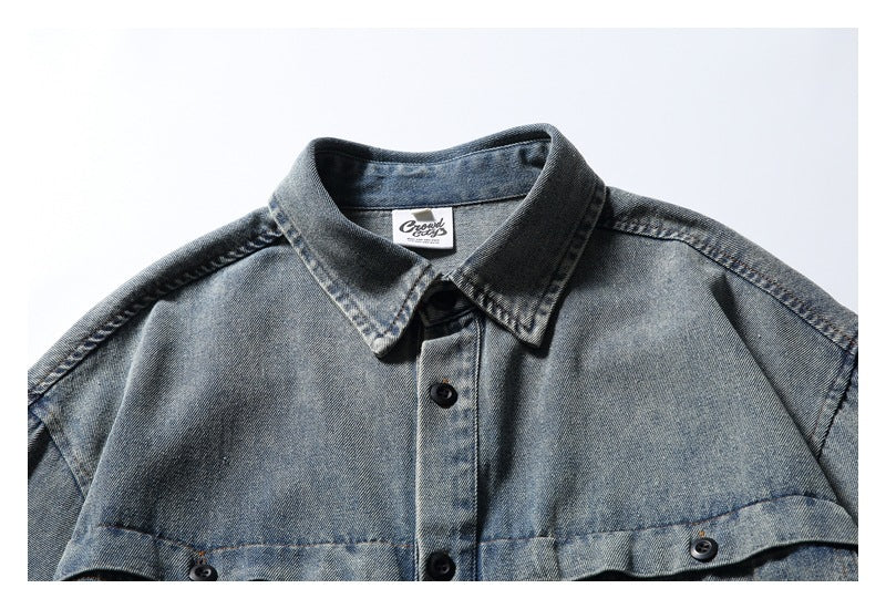 Close-up of the gray washed denim shirt’s pointed collar, button placket and inner neck label.