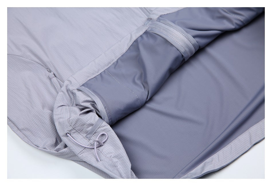 Inside view of a light gray pinstriped garment, showing a darker gray lining, seams and an adjustable cord detail.