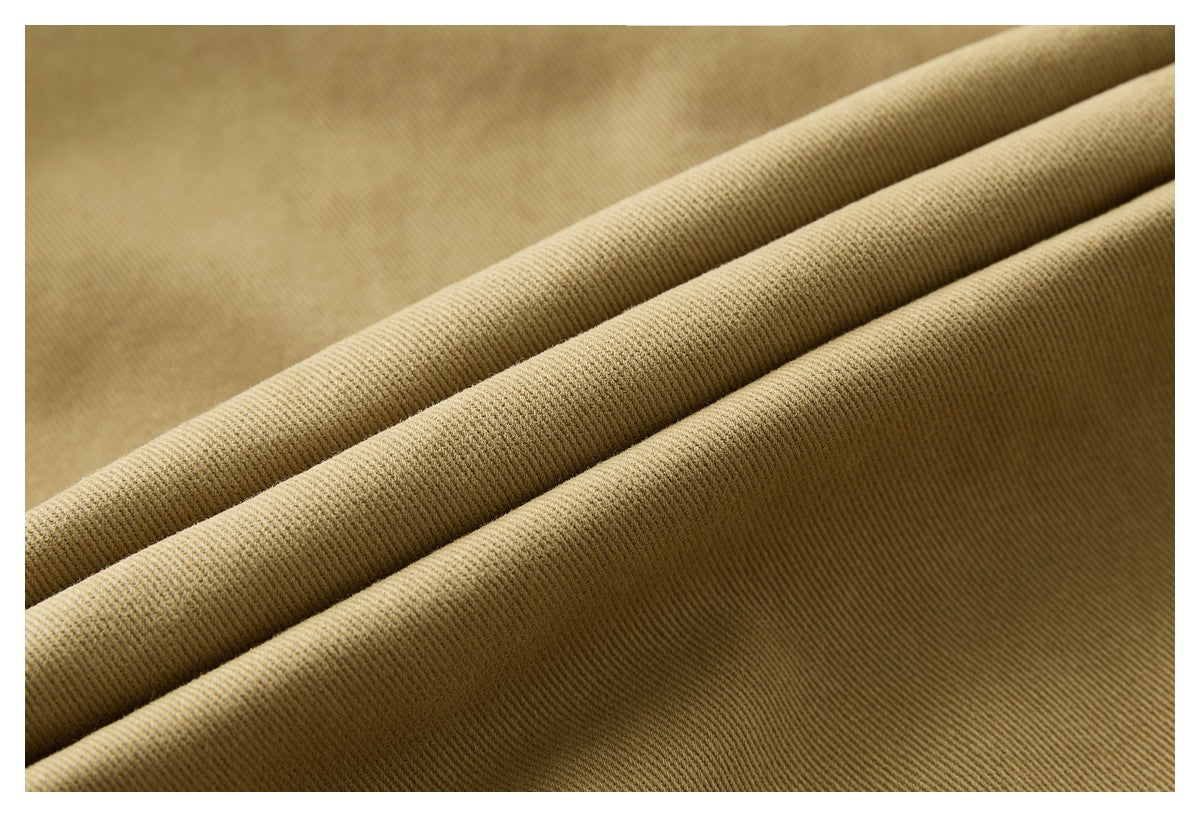 Close-up showing the fine diagonal texture of tan fabric folded into ridges.
