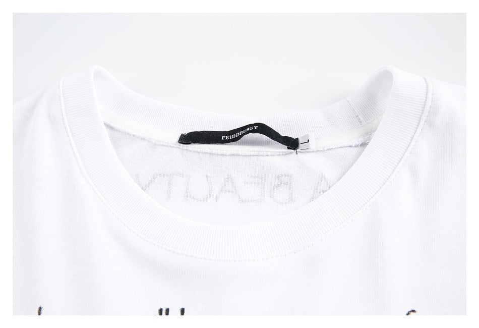 Close-up of a white T-shirt's ribbed crewneck collar and black neck label.