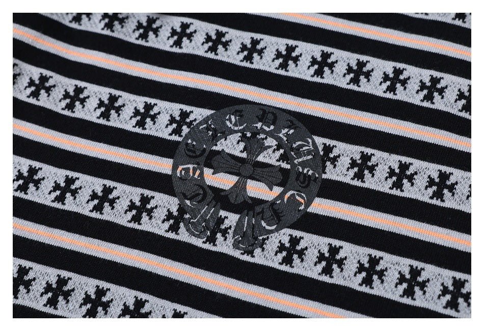 Close-up of a dark circular decorative print on gray patterned stripes with thin peach lines.