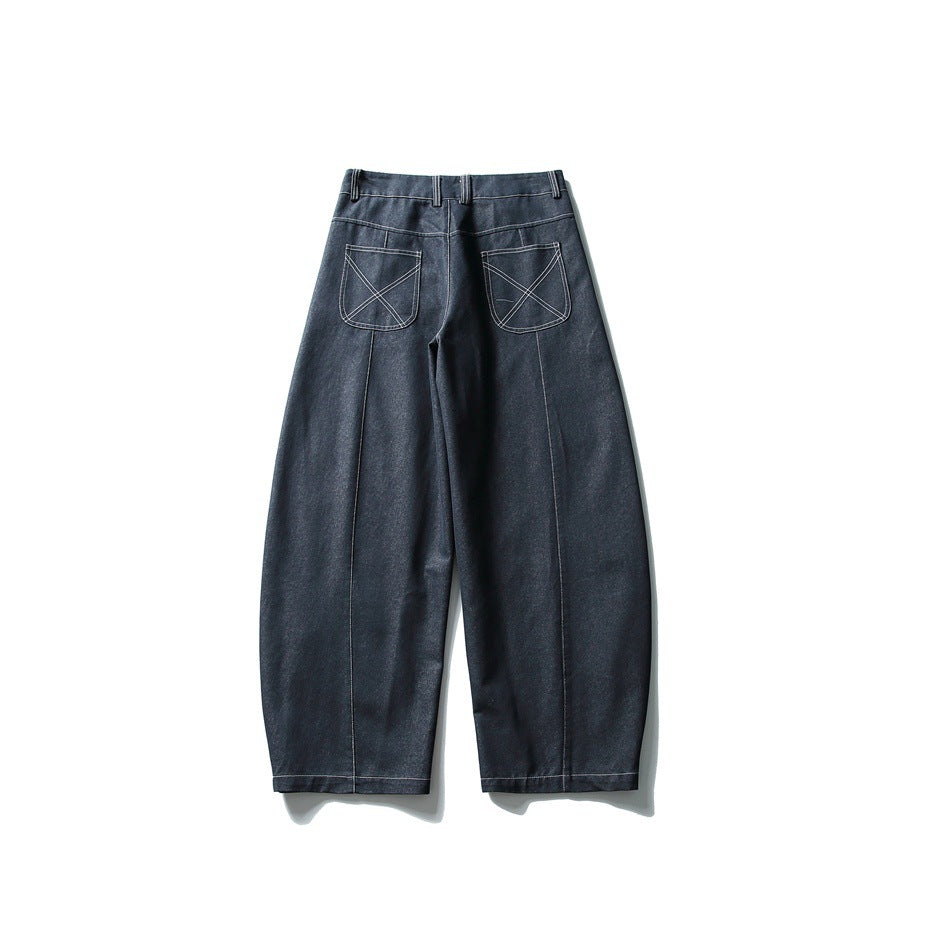Back view of navy wide-leg jeans with X-stitched patch pockets and vertical leg seams