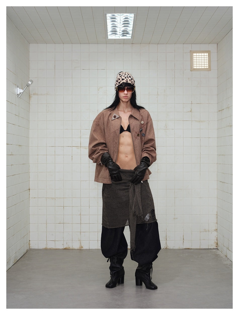 Front view of a model wearing an open brown jacket with decorative buttons and a zip front.