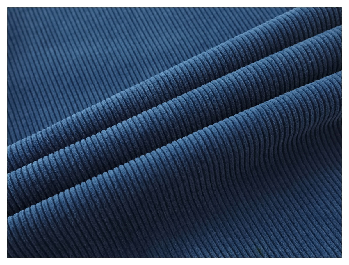 Close-up showing the raised ribs and texture of blue corduroy pants.