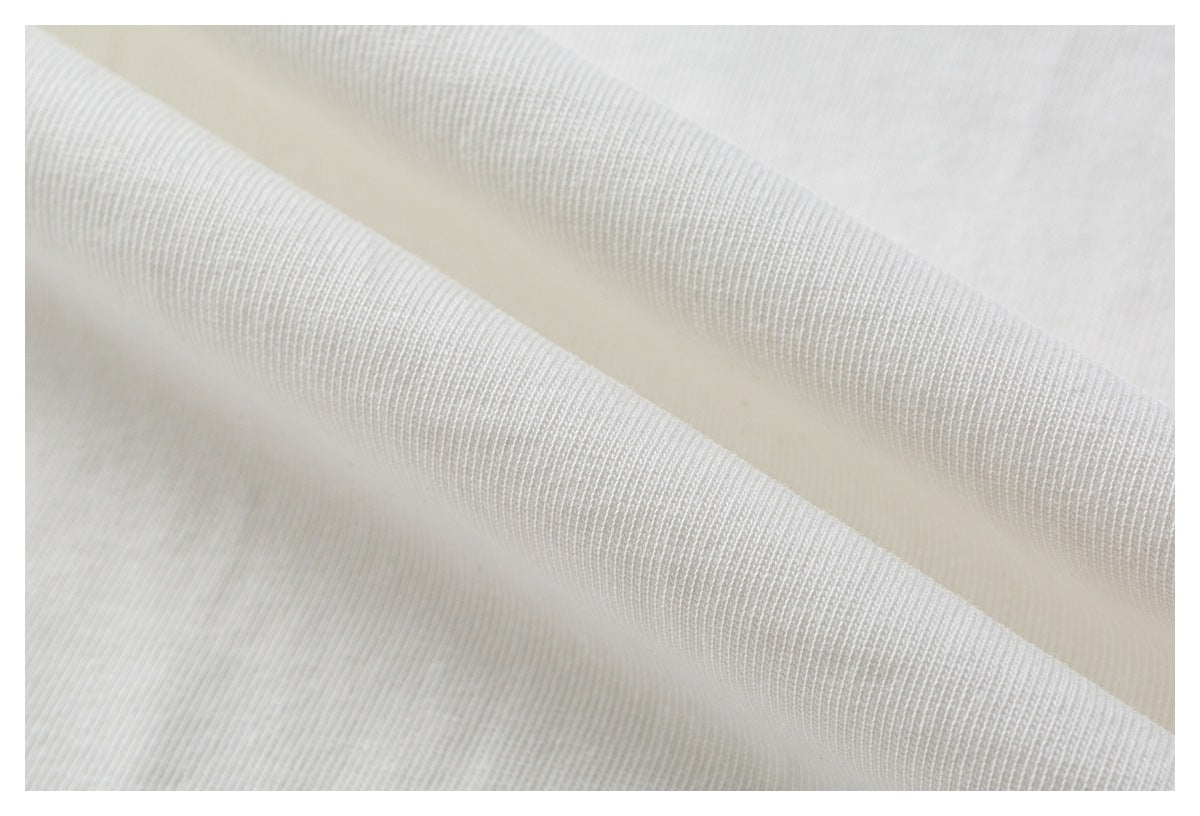 Extreme close-up of white garment fabric folded to show its knit texture.