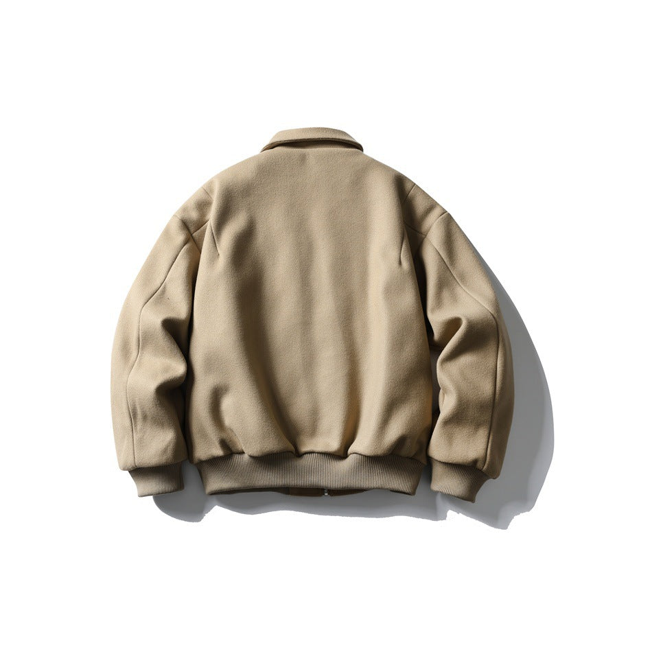 Full back view of a tan jacket with a pointed collar, long sleeves, and ribbed cuffs and hem.