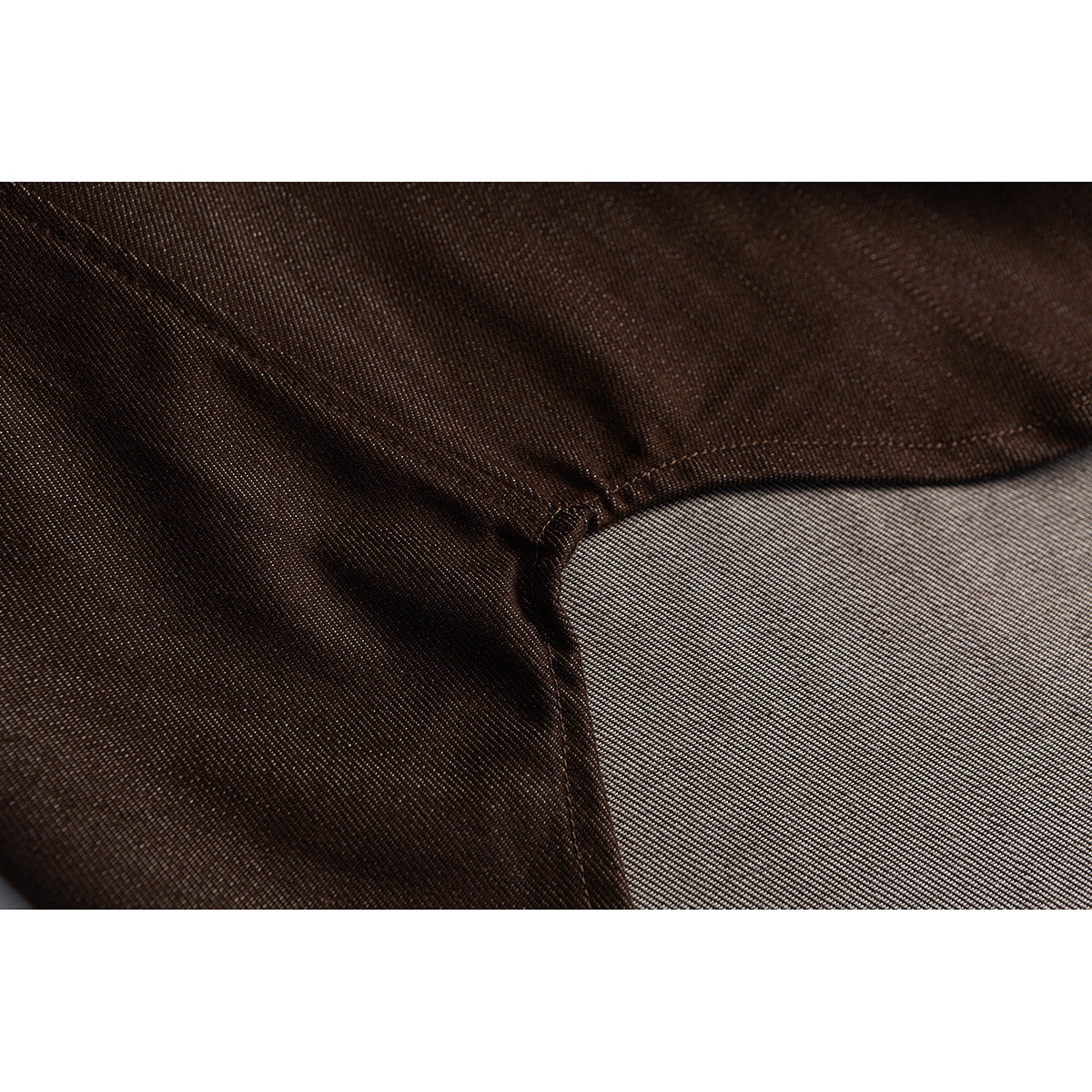 Close-up of dark brown shirt fabric and a stitched seam.