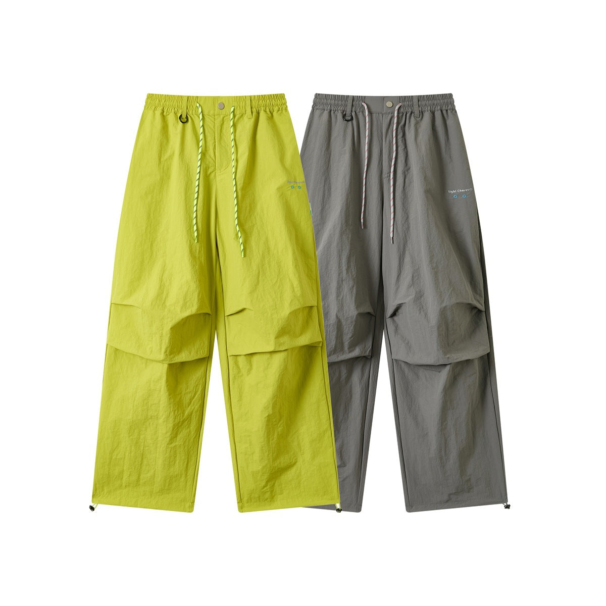 Front views of wide-leg trousers in lime green and gray, with elastic waists, striped drawcords, and cargo-style panels.