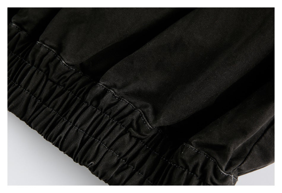 Close-up of a gathered elastic waistband on black fabric.