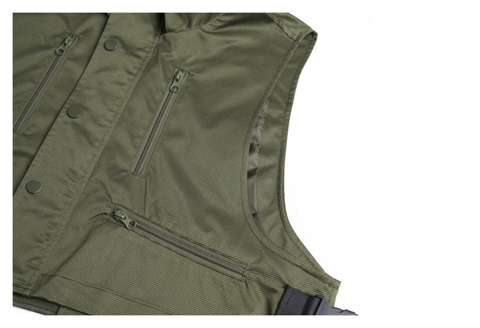 Angled detail of the olive-green vest showing zip pockets, snap-front placket, and side strap.