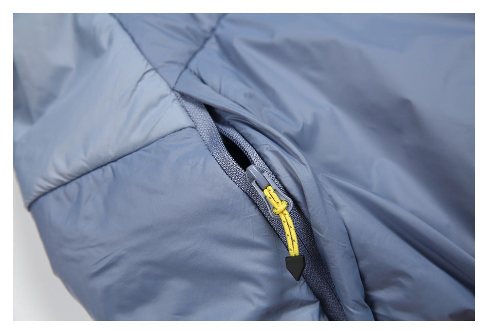 Close-up of a blue-gray jacket pocket zipper with a bright yellow pull cord and black tip.