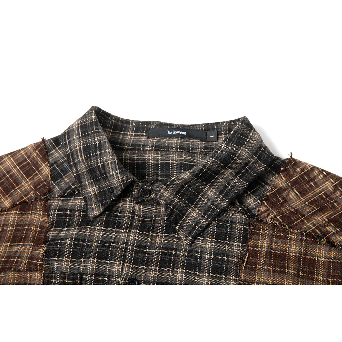 Close-up of a charcoal and brown plaid shirt collar, button, and contrasting shoulder panels.