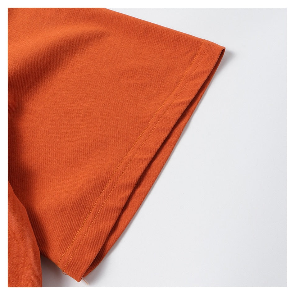 Close-up of an orange garment sleeve edge with a stitched hem.