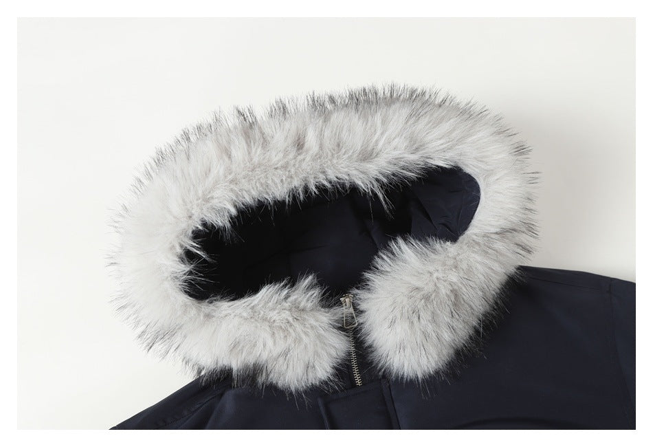 Close-up of a navy coat hood framed with thick light gray faux fur.
