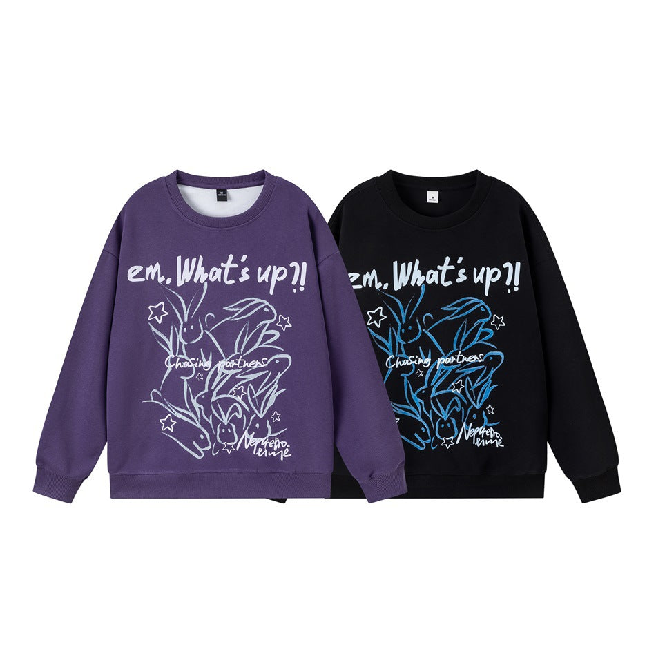 Two crewneck sweatshirts shown from the front: purple with a pale graphic and black with a blue graphic.