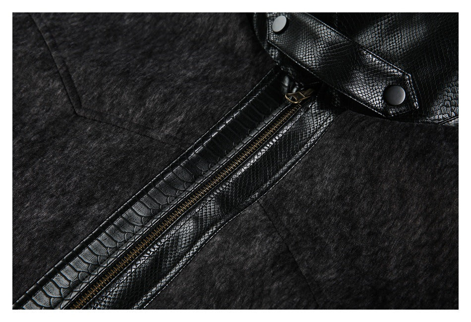 Close-up of a charcoal heather jacket with a diagonal zipper and glossy black reptile-textured trim.