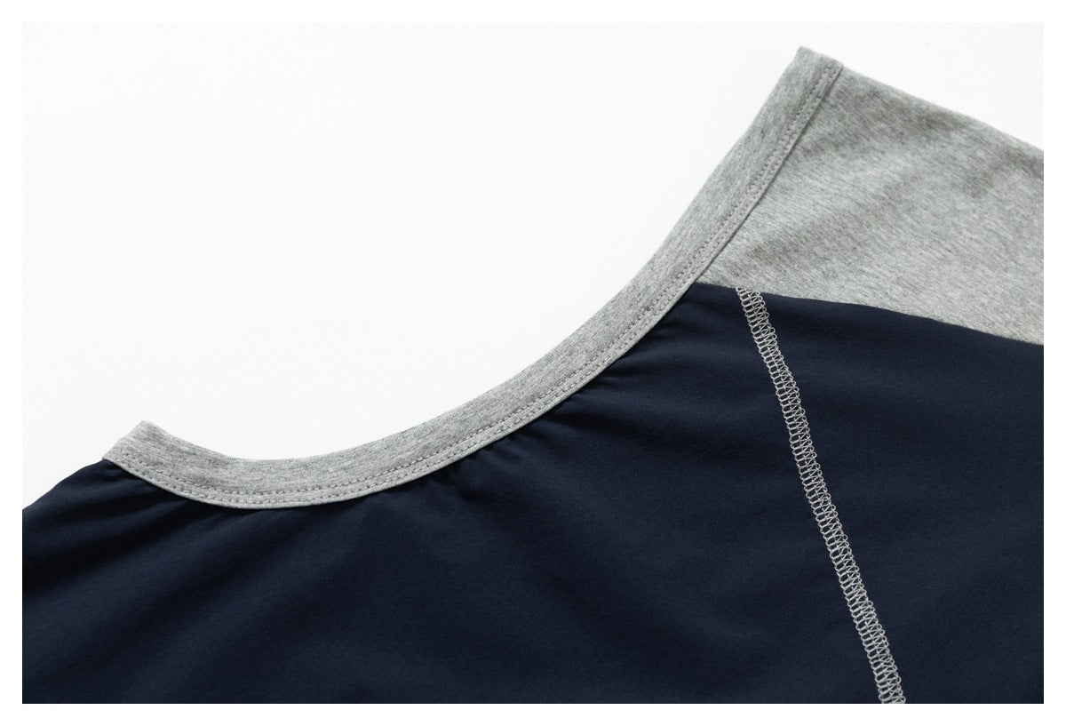 Close-up of the gray crew-neck binding and gray overlock seam on a navy shirt.