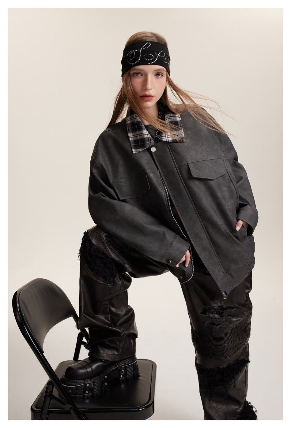 Model wearing an oversized charcoal jacket with plaid collar, flap chest pockets, and front zipper.