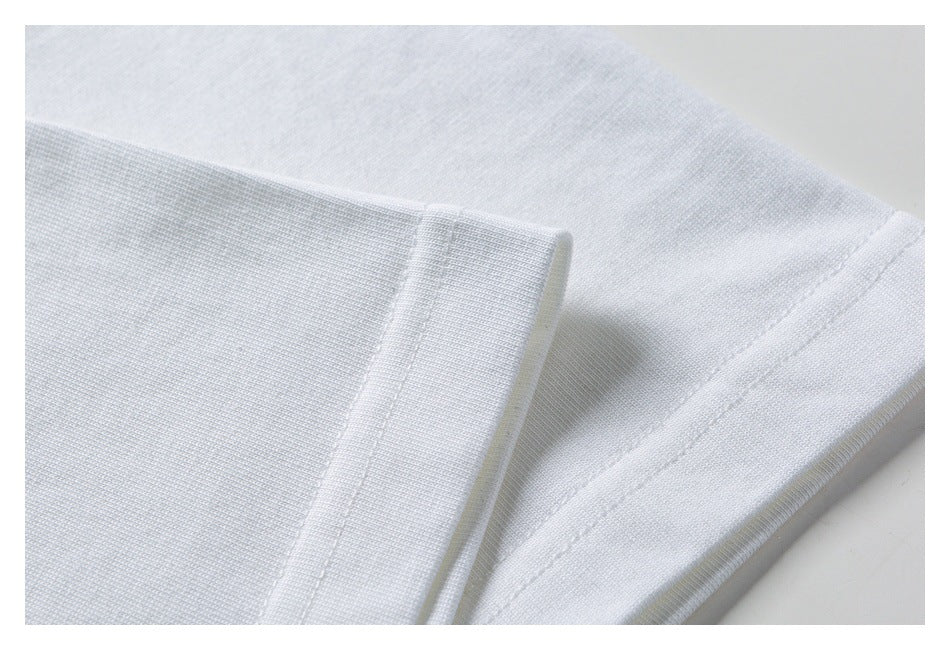 Close-up of the white T-shirt sleeve edge and stitched hem.