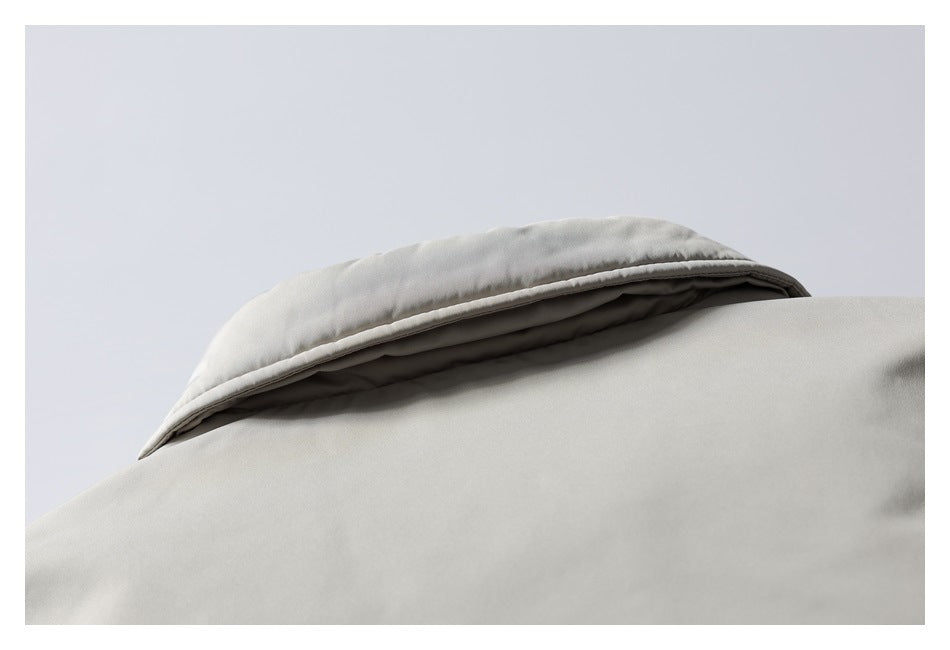 Close-up of the light gray jacket's folded collar and upper front.