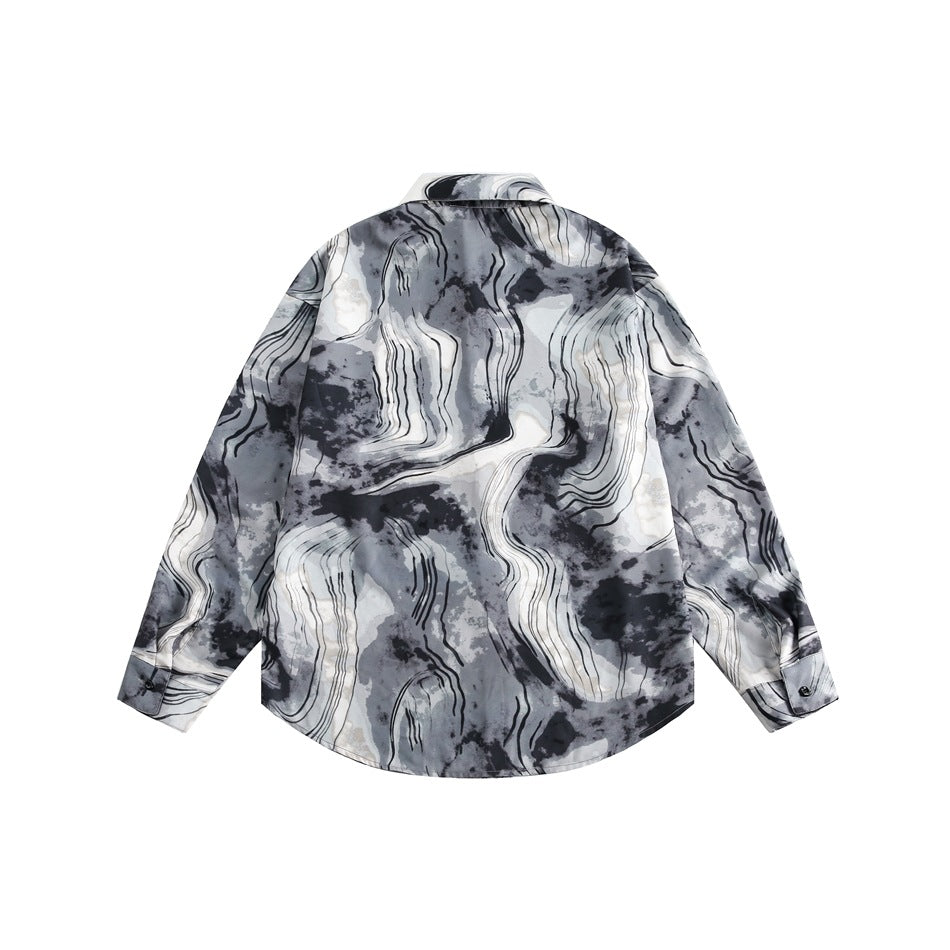 Back view of a long-sleeved gray, black, and ivory abstract-print shirt on a white background.