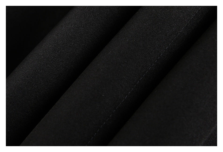 Close-up of black fabric folds and a stitched seam.