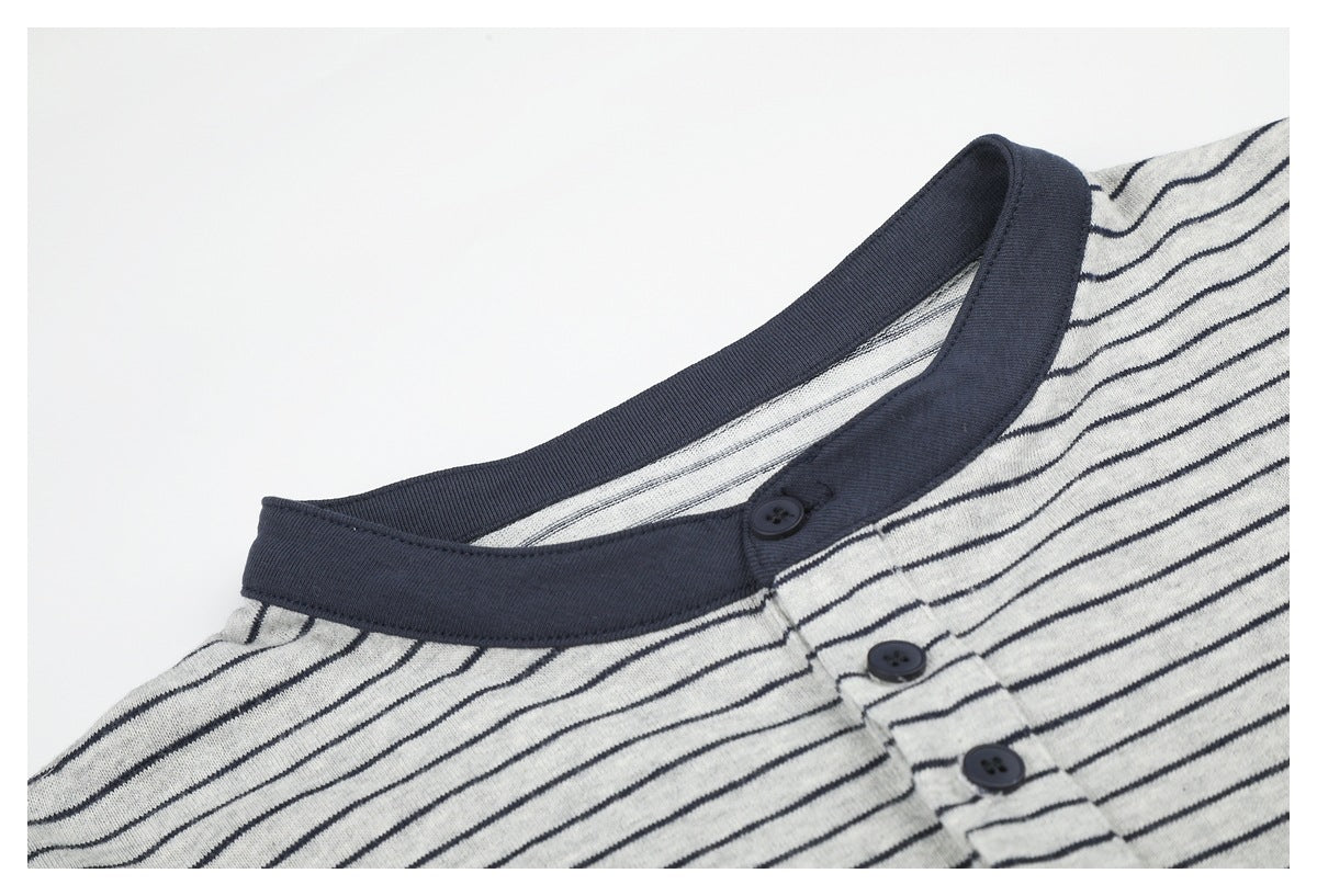 Close-up of the shirt's dark ribbed collar, striped fabric, and upper buttons.