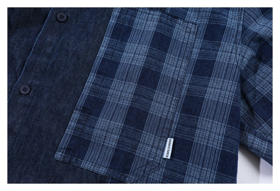 Close-up of a blue plaid chest pocket on a dark navy button-up shirt.