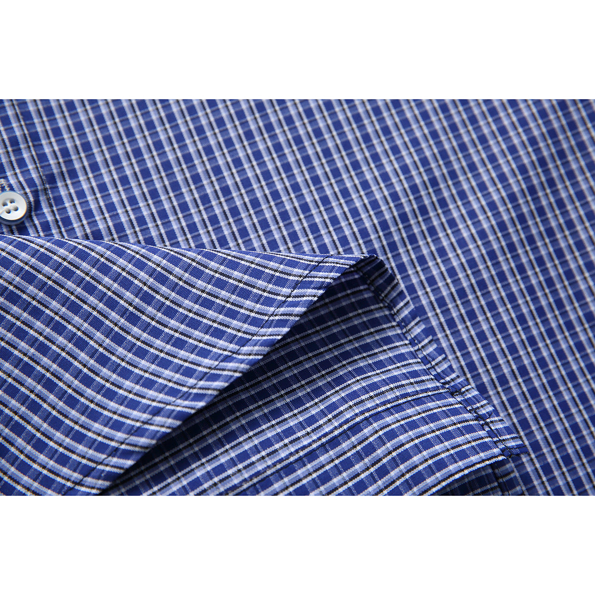 Close-up of blue-and-white checked shirt fabric and a folded, stitched edge.