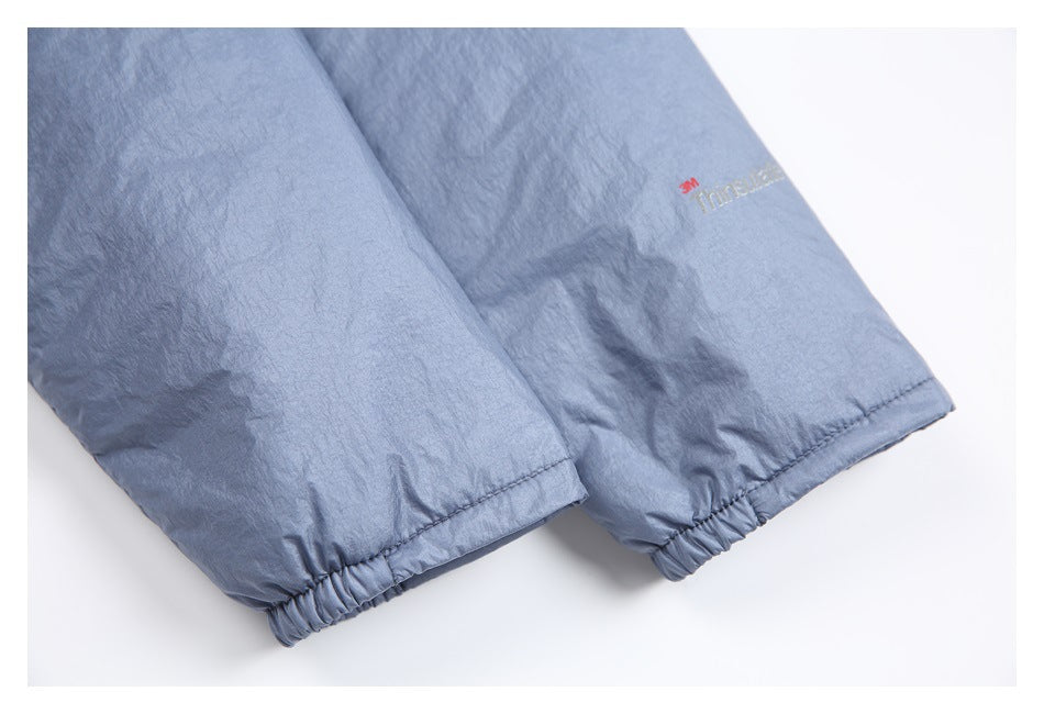 Blue-gray garment cuffs with elasticated hems and a small red 3M Thinsulate mark.