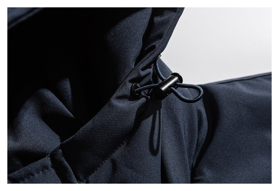 Close-up of a navy jacket hood drawcord with a black cord lock.