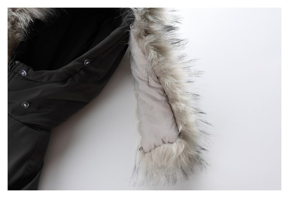 Close-up of a black coat opening with snap fasteners and a light faux-fur-trimmed hood.