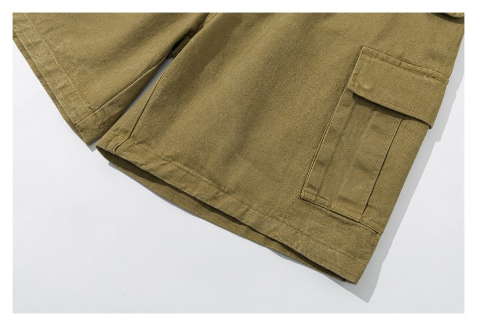 Partial view of olive-khaki cargo shorts showing the hems and leg cargo pockets.