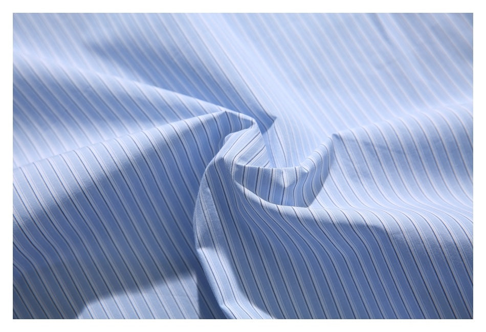 Close-up of light blue fabric with narrow white stripes, loosely draped to show its folds.