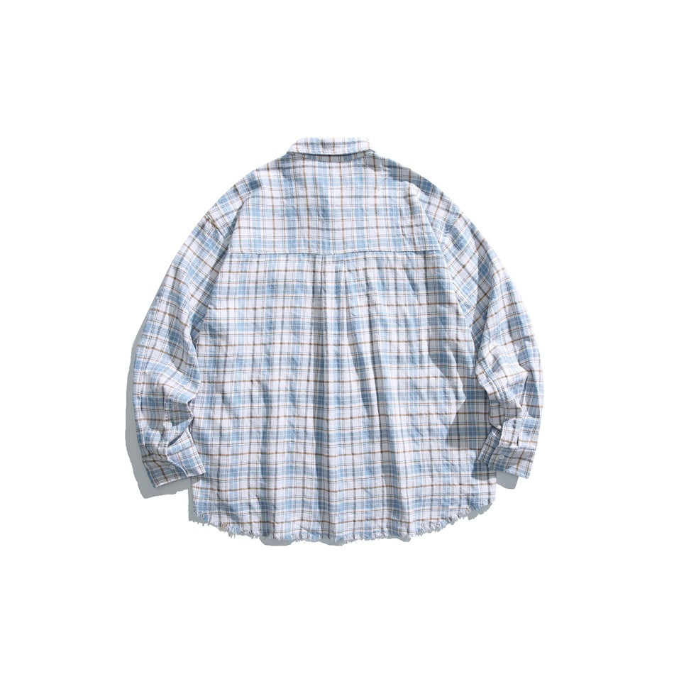 Back view of a pale blue, gray, and tan plaid button-up shirt with a yoke and frayed hem.