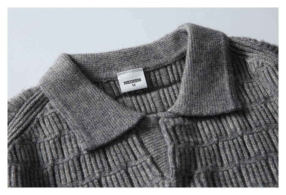 Close-up of the sweater’s fold-over collar, textured knit, and sewn neck label.