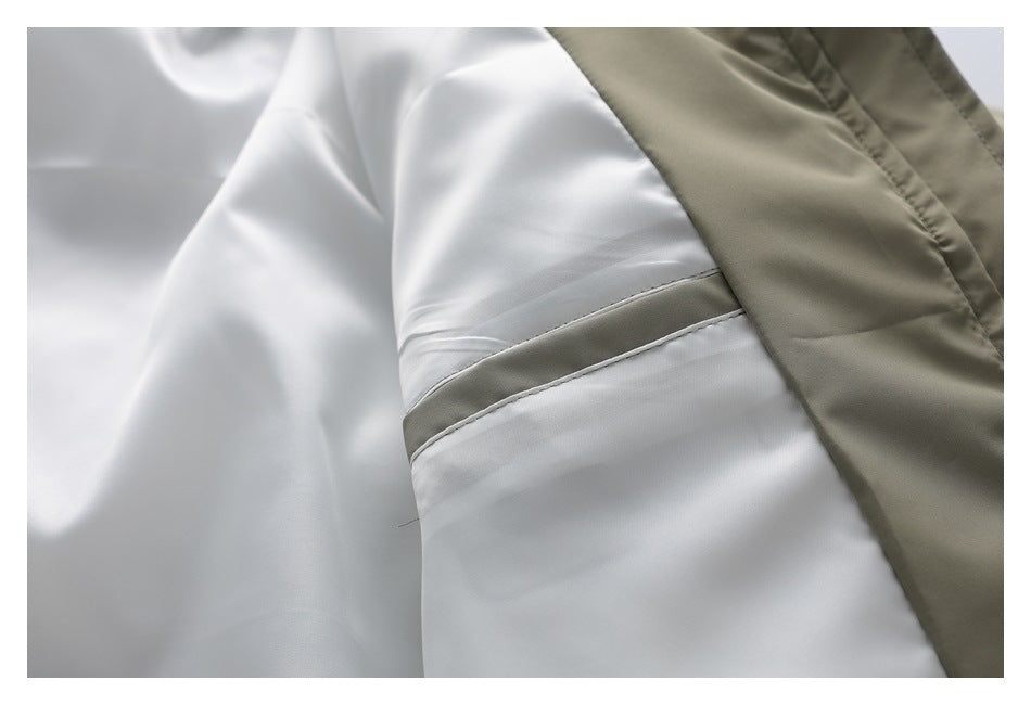 Close-up of the jacket's white inner lining and olive-khaki outer shell at a seam.
