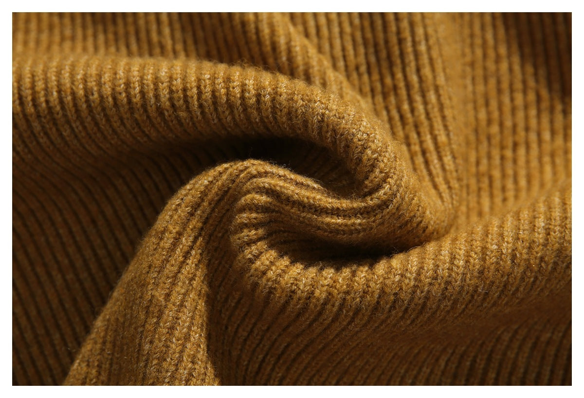 Close-up of warm brown ribbed knit fabric folded into soft curves.