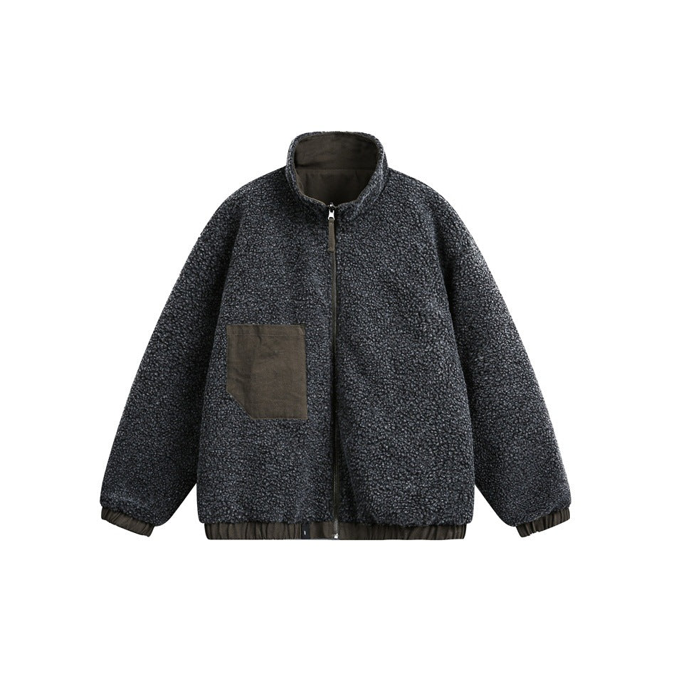Front view of a charcoal textured zip-up jacket with a stand collar, olive patch pocket, and gathered trim.