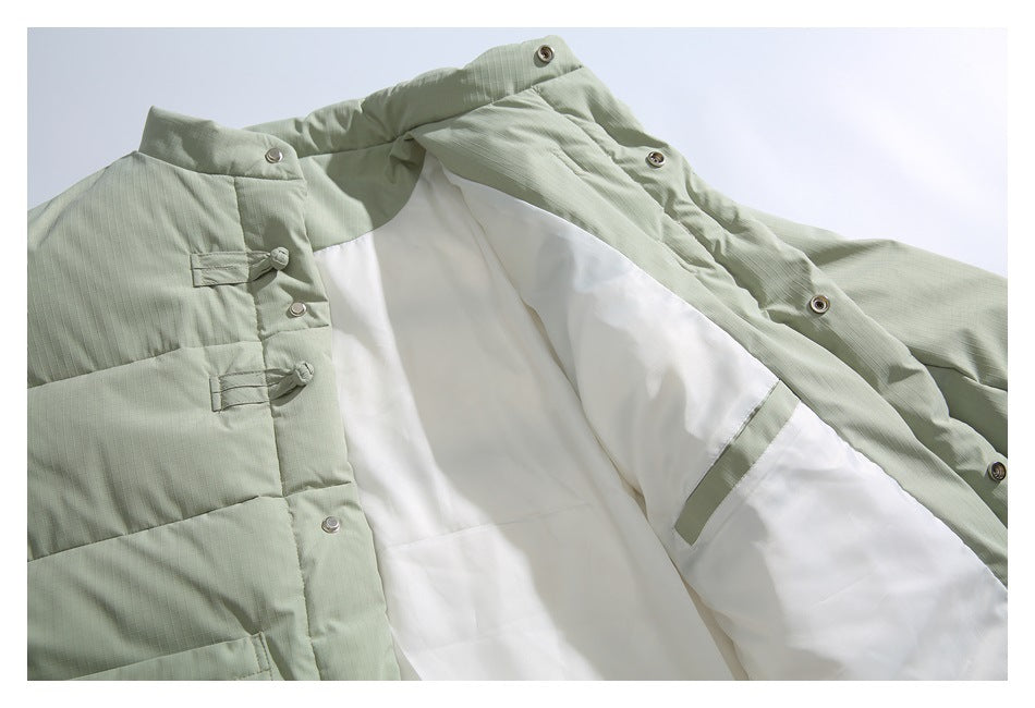 Open pale sage jacket showing white lining, snap fasteners, and fabric frog closures.